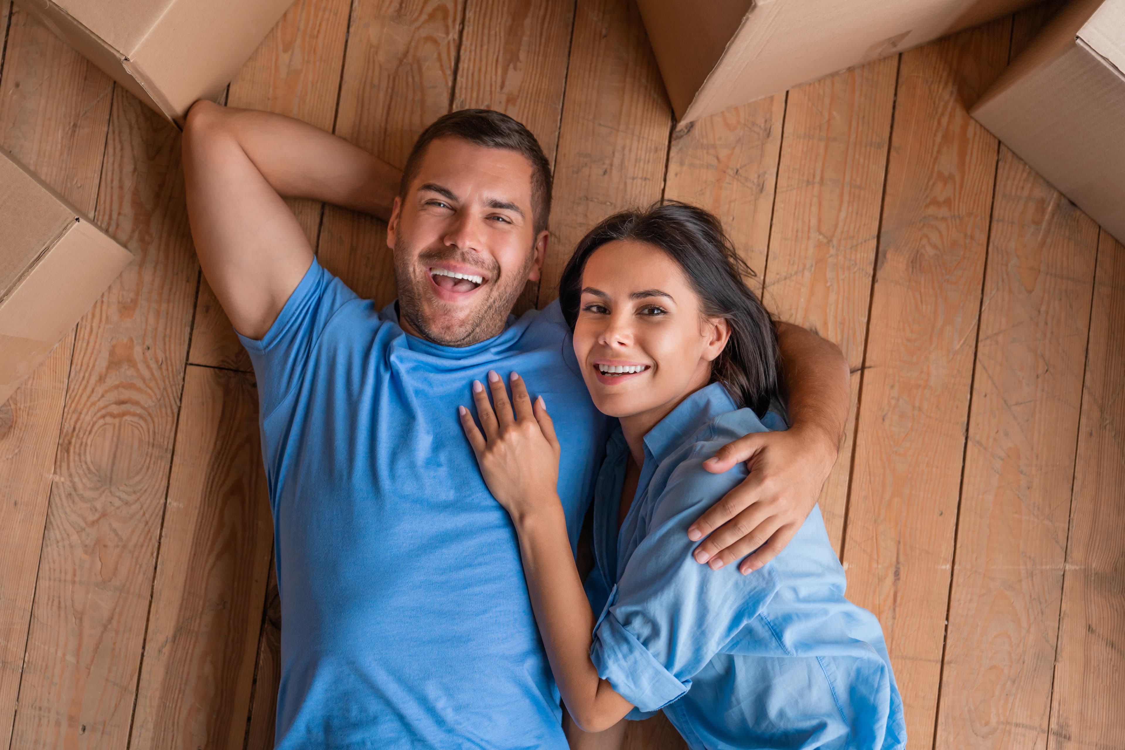 Couple enjoying laying on solid engineered wood flooring