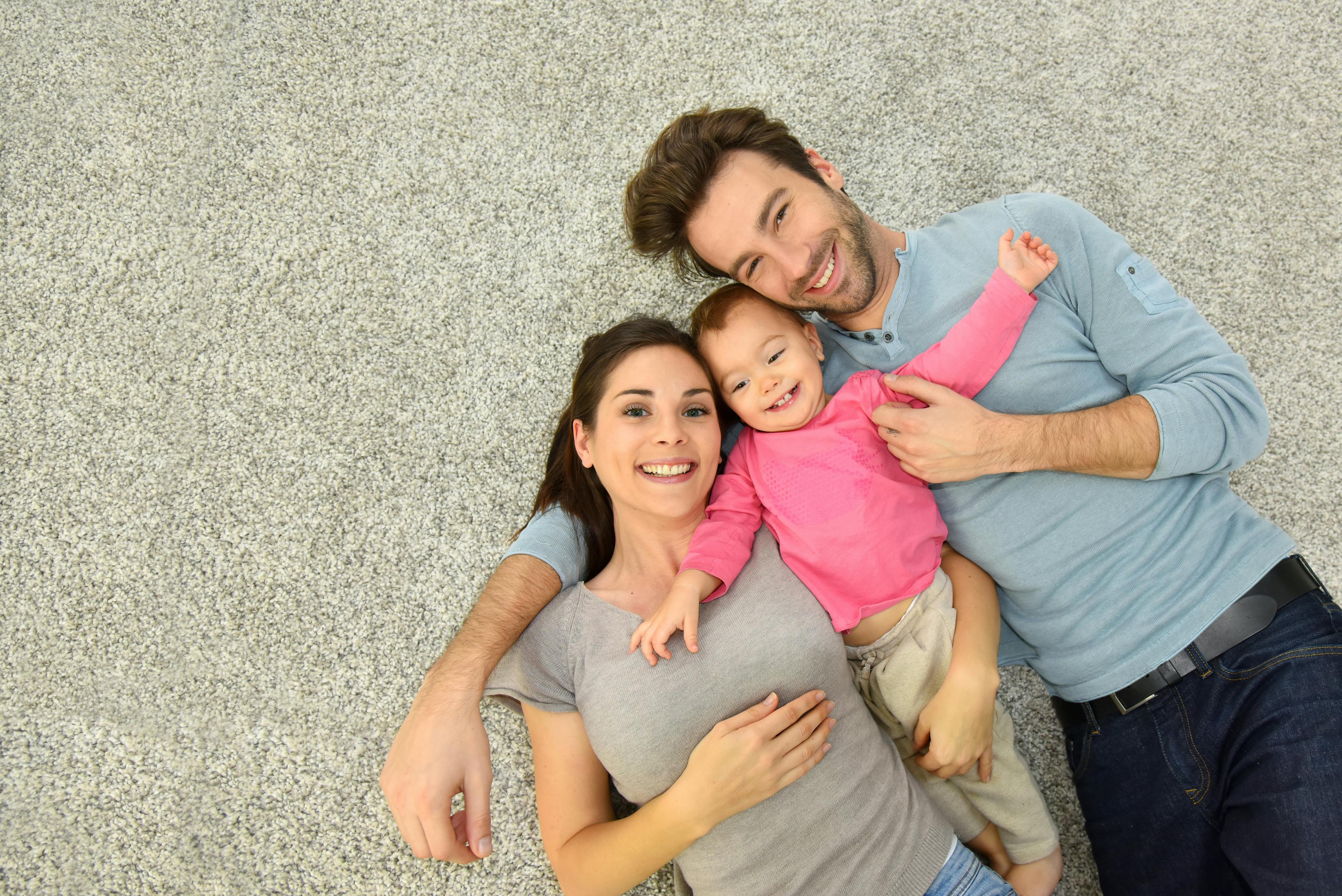 A family relaxing on twist pile carpet